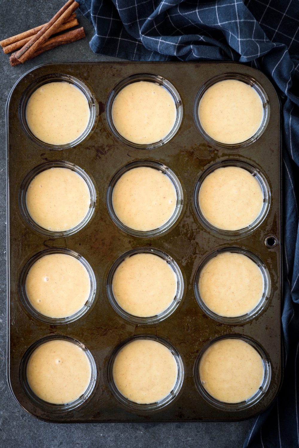 A muffin tin filled with muffin batter.