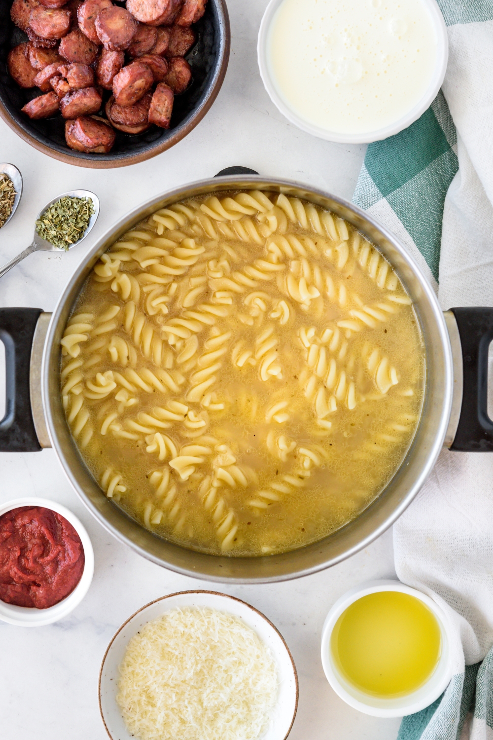 A pot with pasta noodles cooking in it.