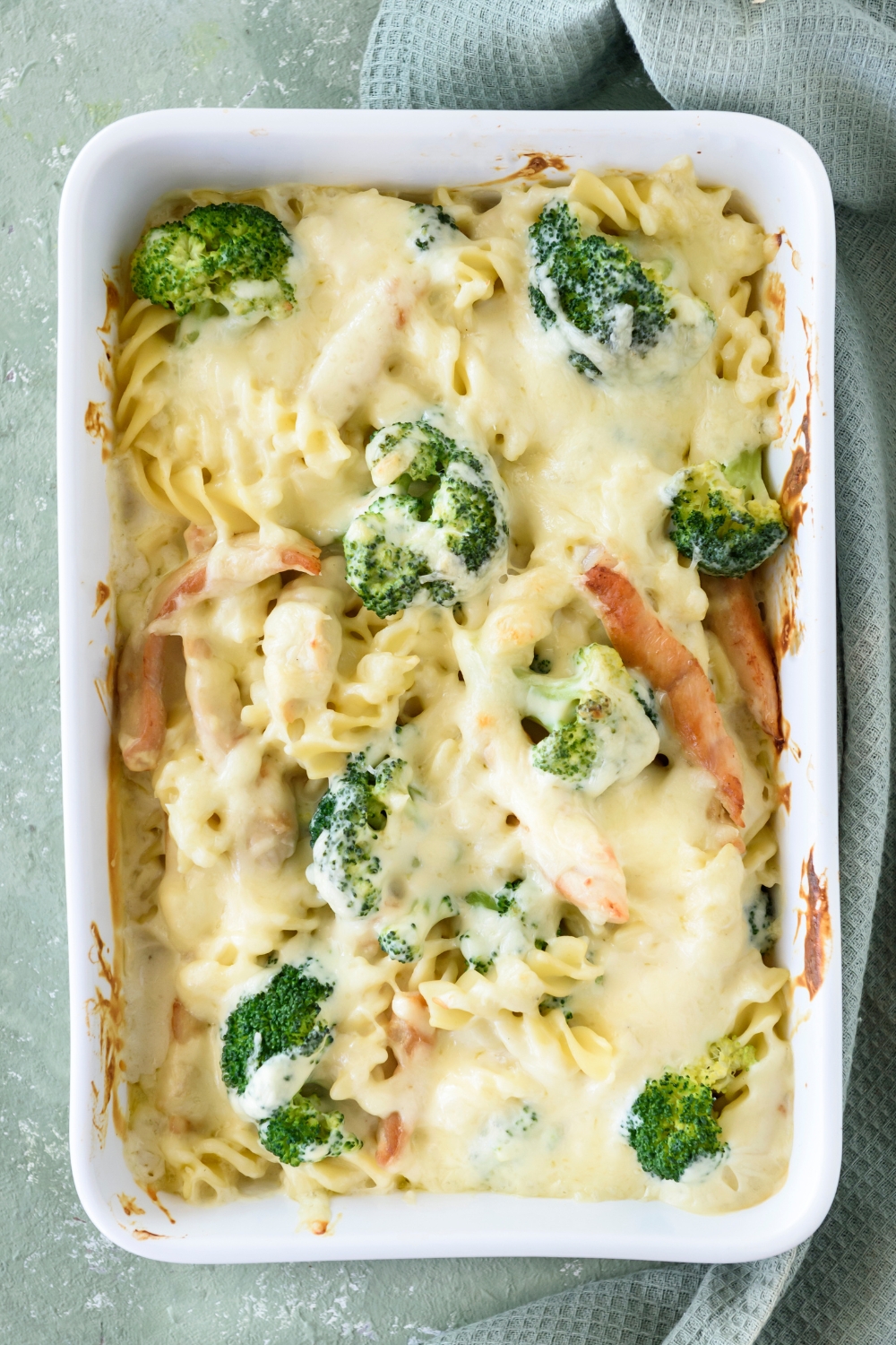 A baking dish filled with freshly chicken and broccoli pasta.