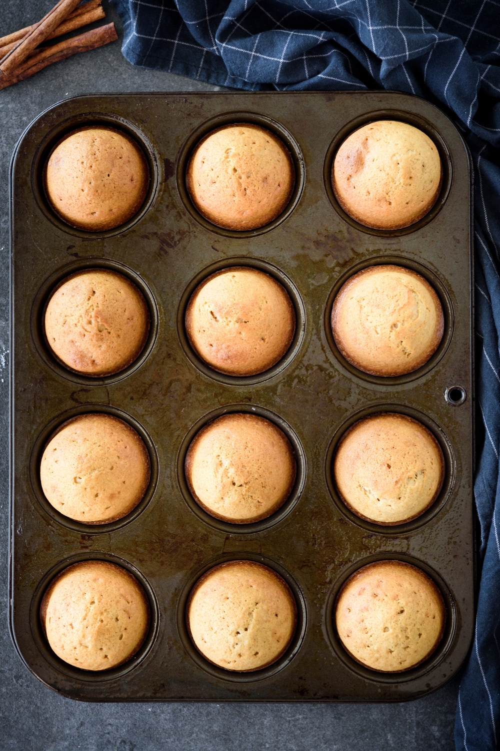 A muffin tin with freshly baked muffins in it.