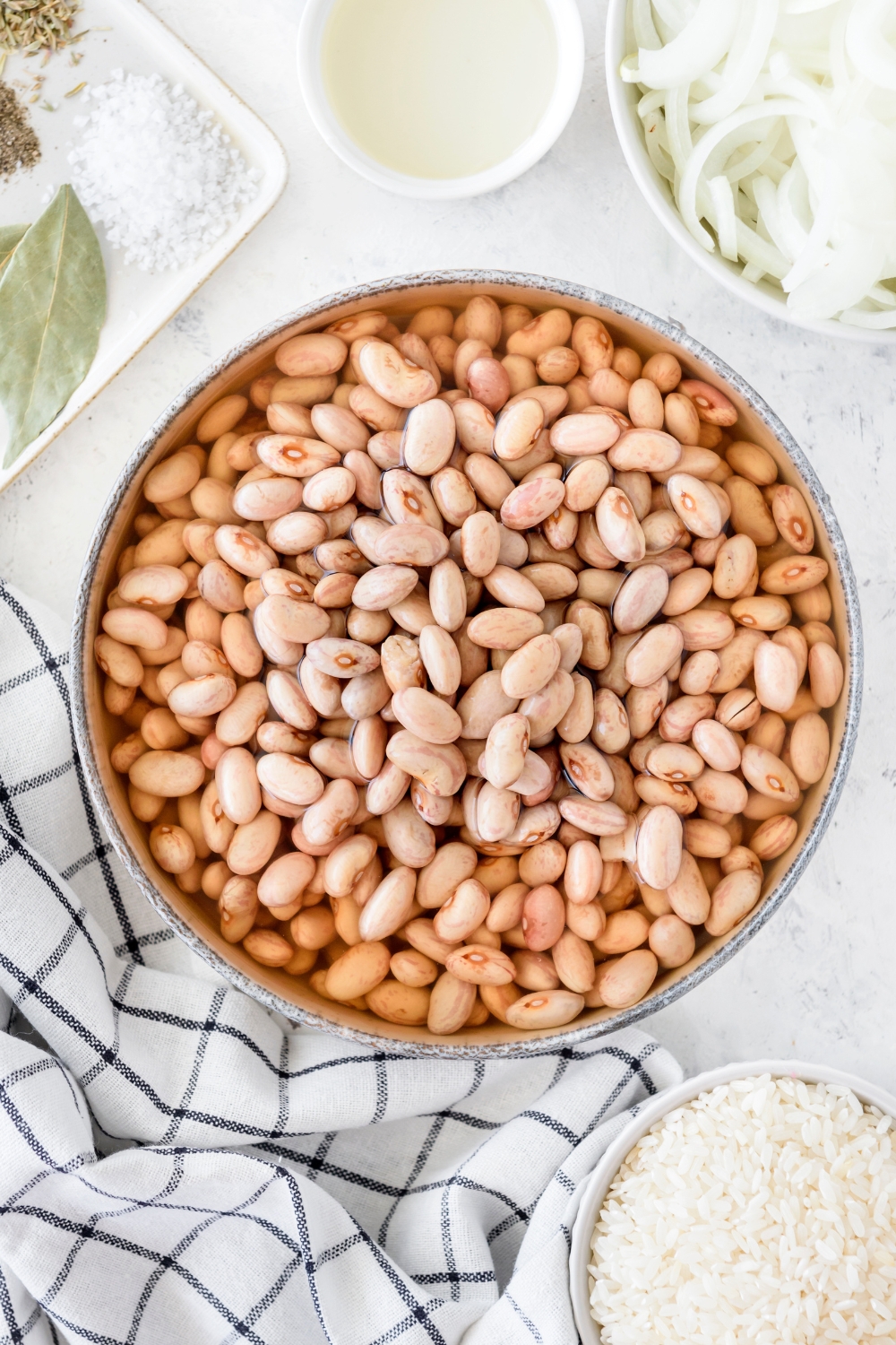 A bowl of dried beans soaking in water.