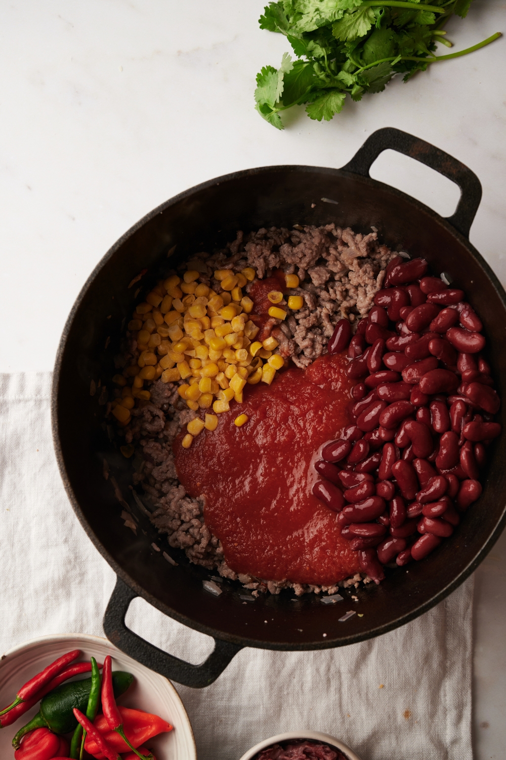 Ingredients for Mexican chili in a black pot
