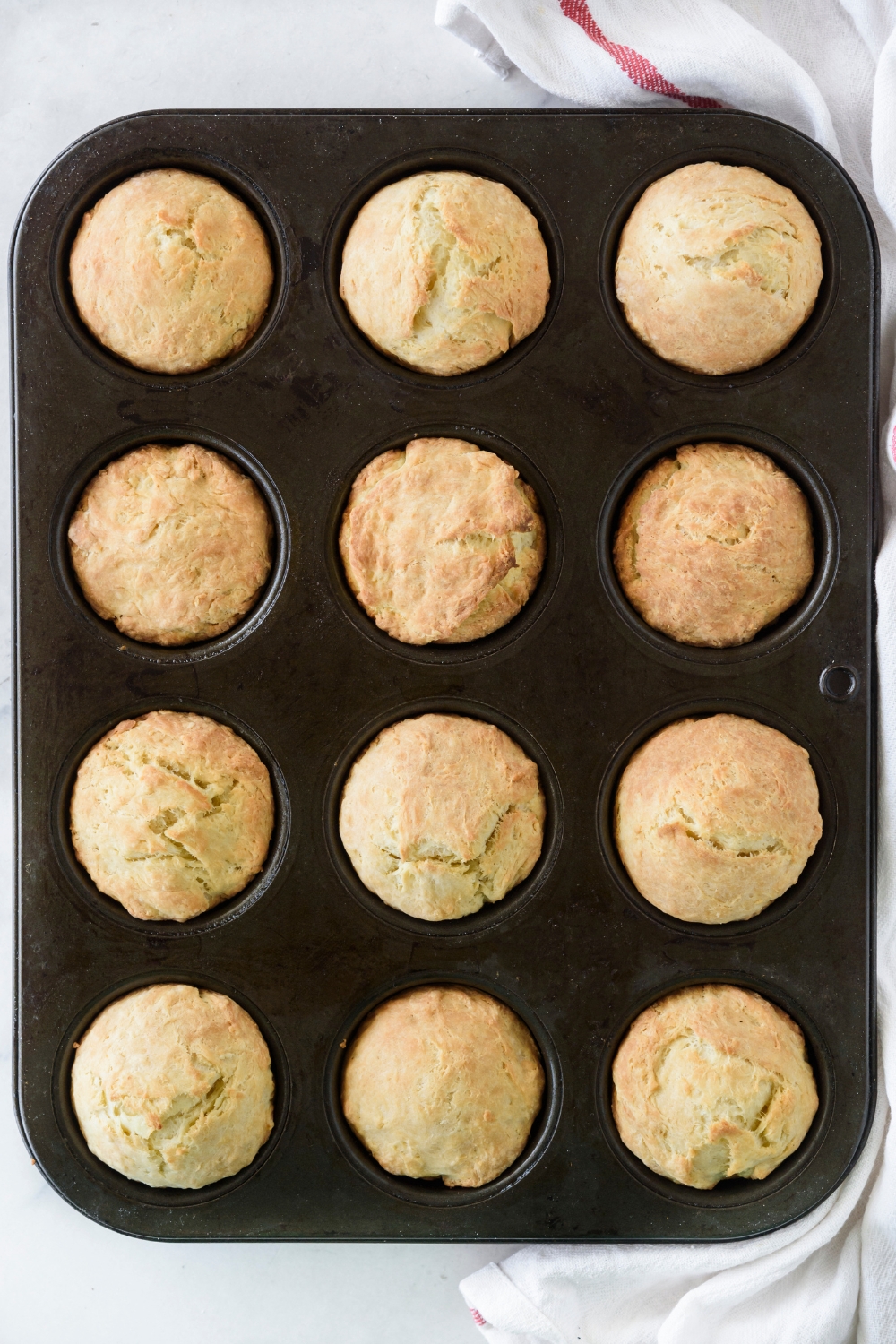 Baked biscuits in a black muffin pan