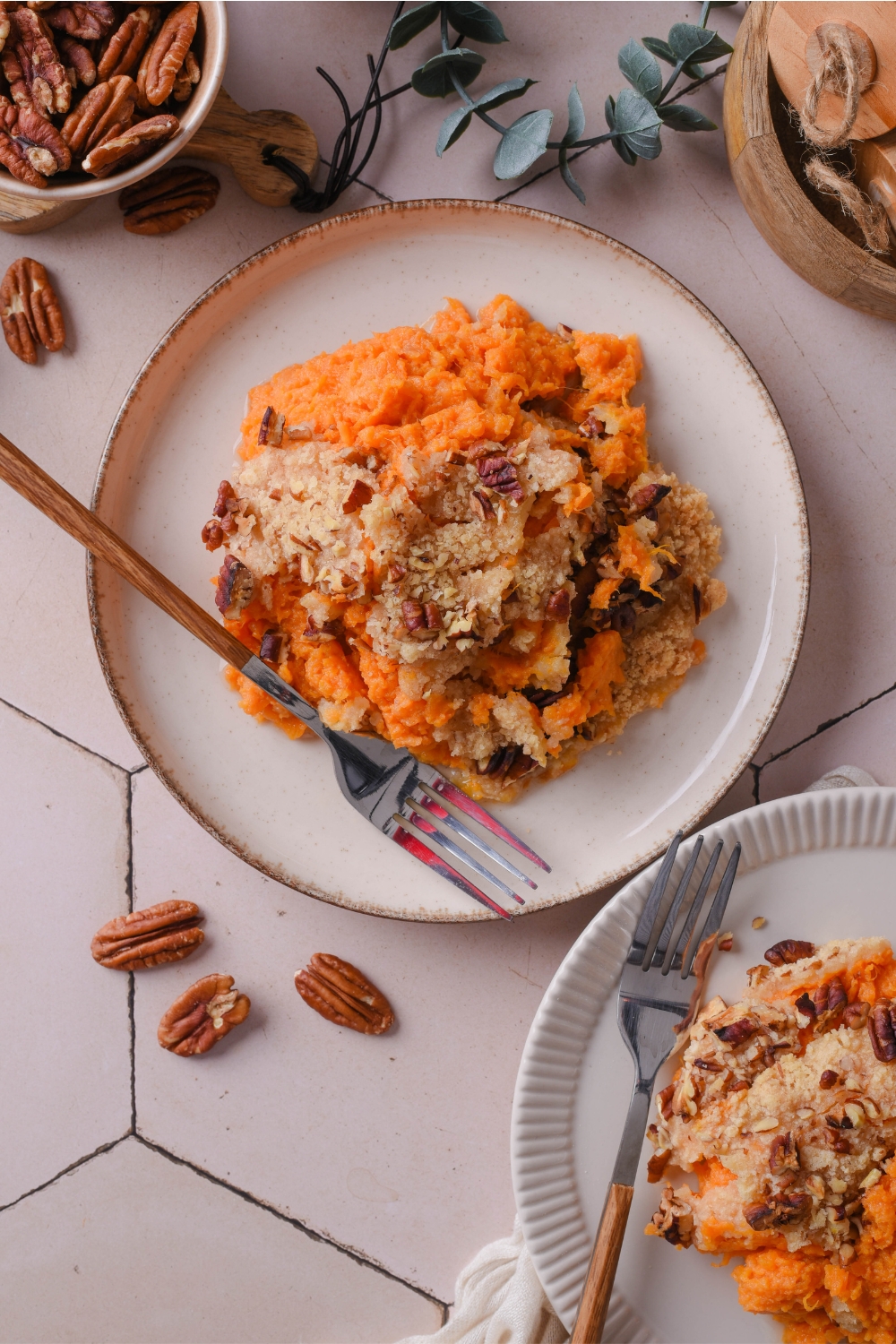 A plate with pumpkin casserole with crumbly pecan topping. A fork is next to it.