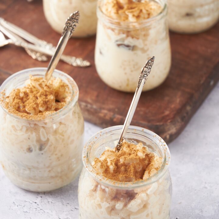 Jars with rice pudding and spoons in each jar.