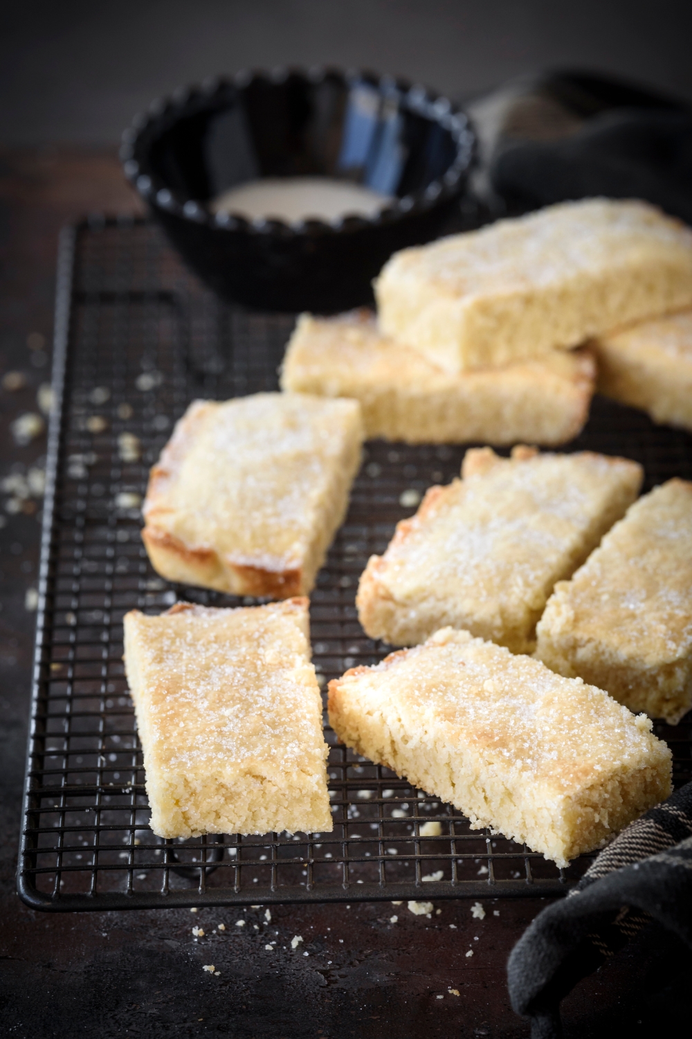 Rectangular biscuits on a cooling rack sprinkled with sugar.