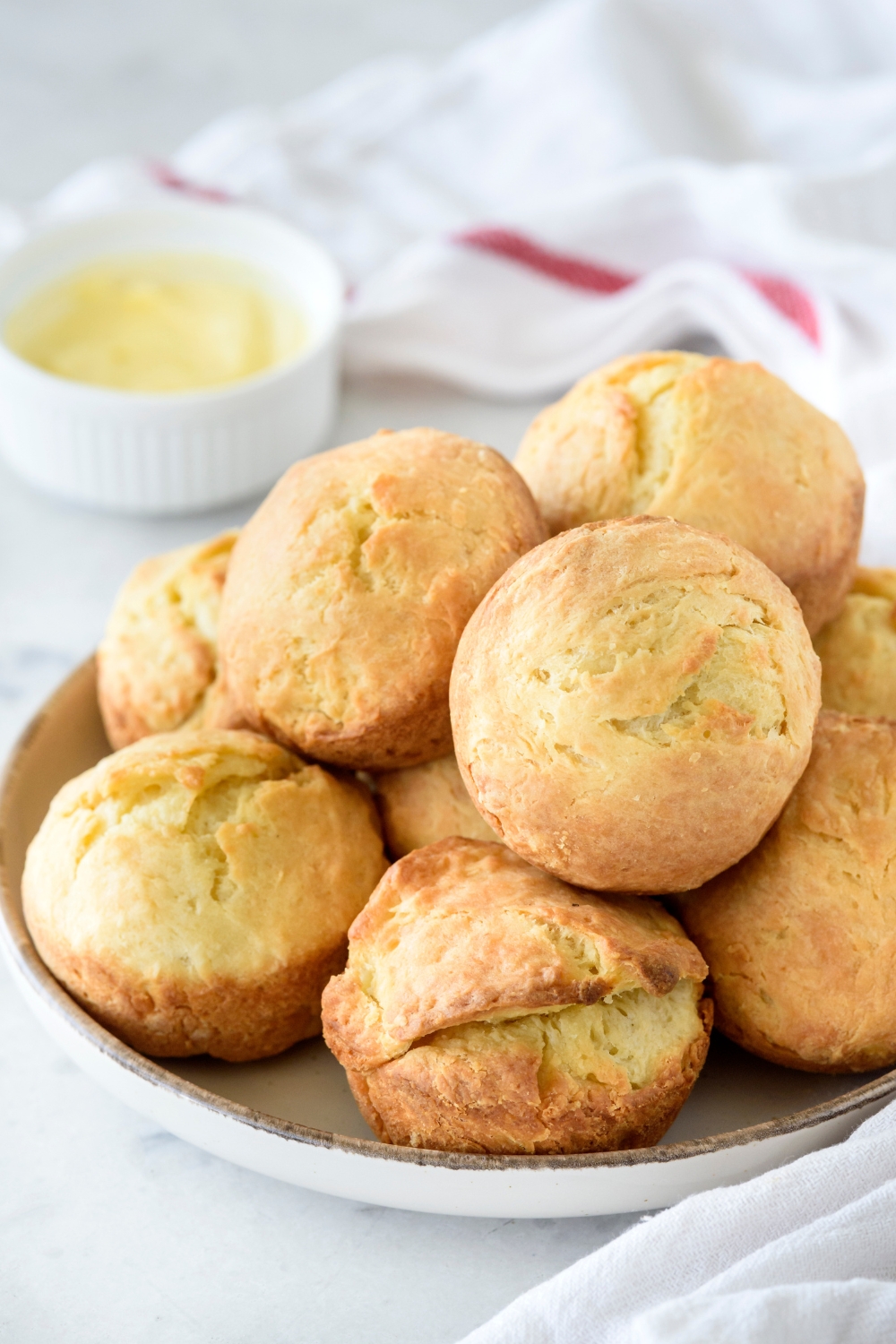 A pile of baked biscuits on a white plate