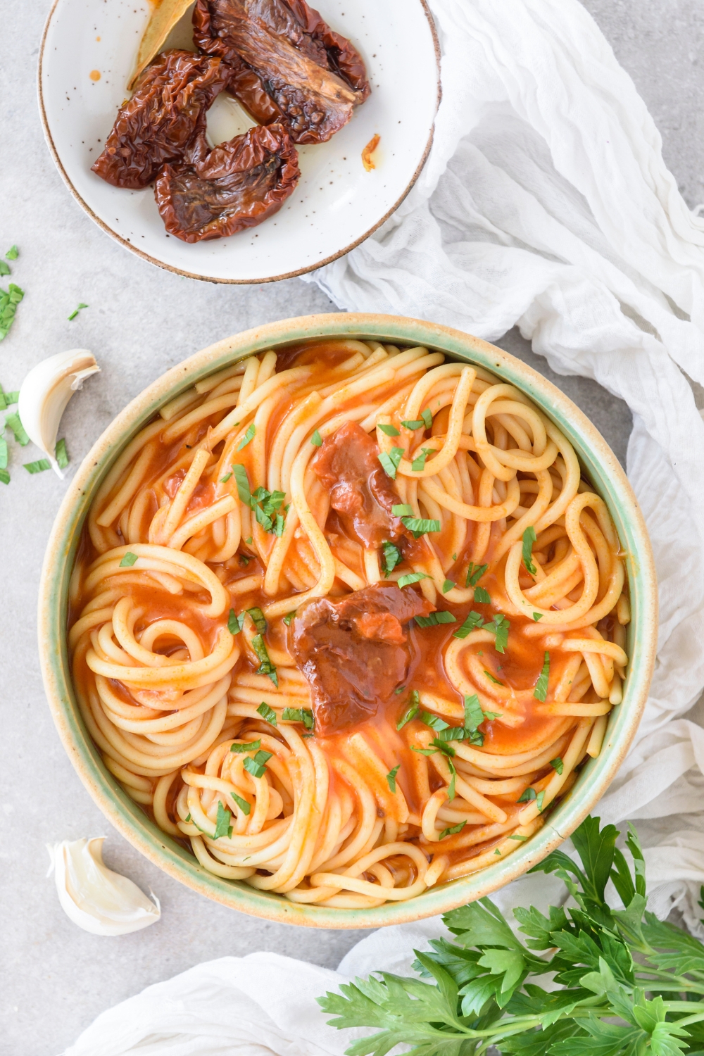 A bowl of spaghetti noodles covered in tomato sauce.