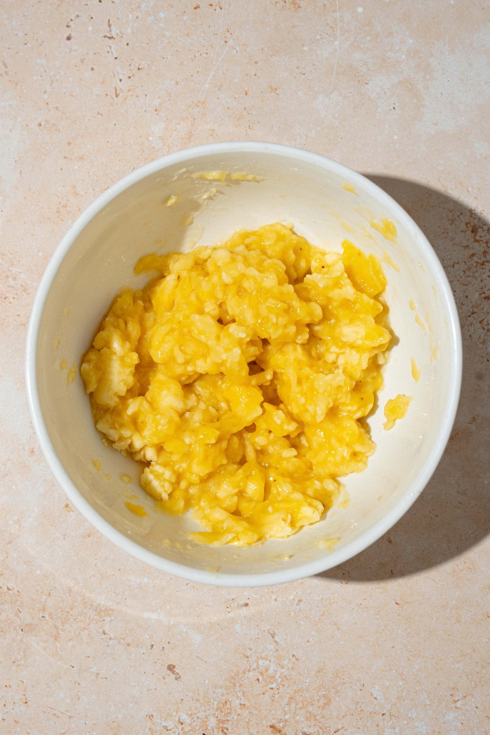 A bowl of mashed banana bananas for almond flour banana muffins.
