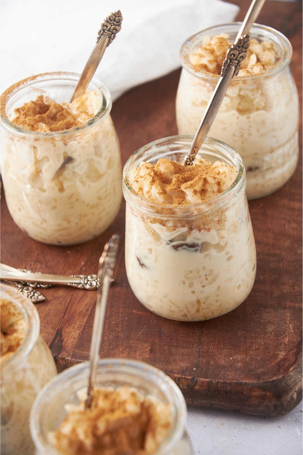 Jars with rice pudding and spoons in each jar.