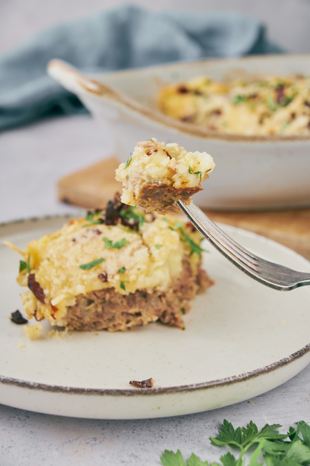 A fork full of cooked meatloaf casserole