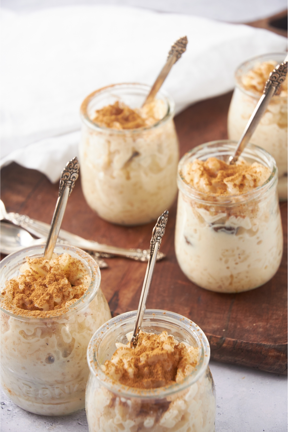 Jars with rice pudding and spoons in each jar.