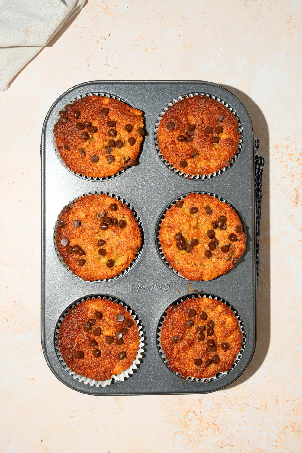 Six muffin tins with almond flour banana muffins in each tin.