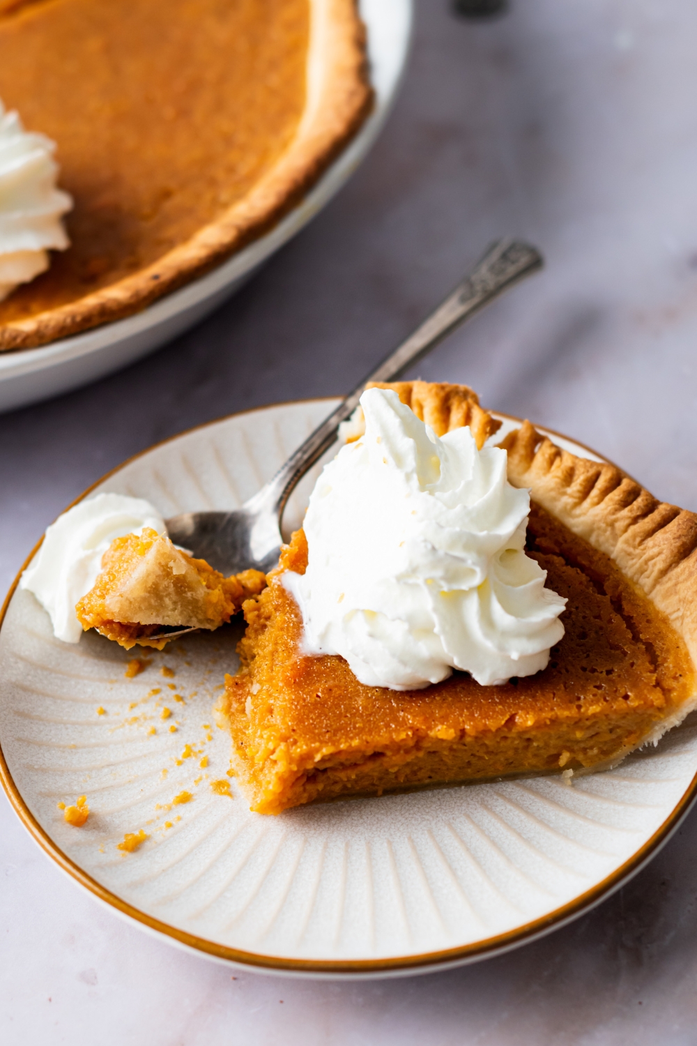 A slice of sweet potato pie on top of a white plate.