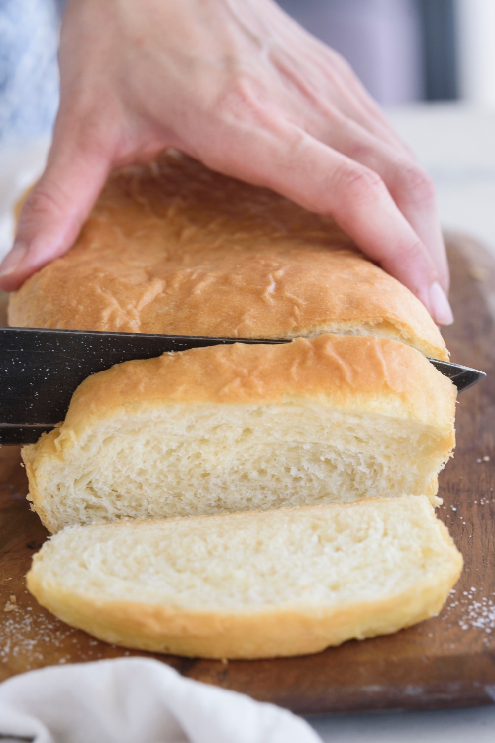 A loaf of bread being sliced.