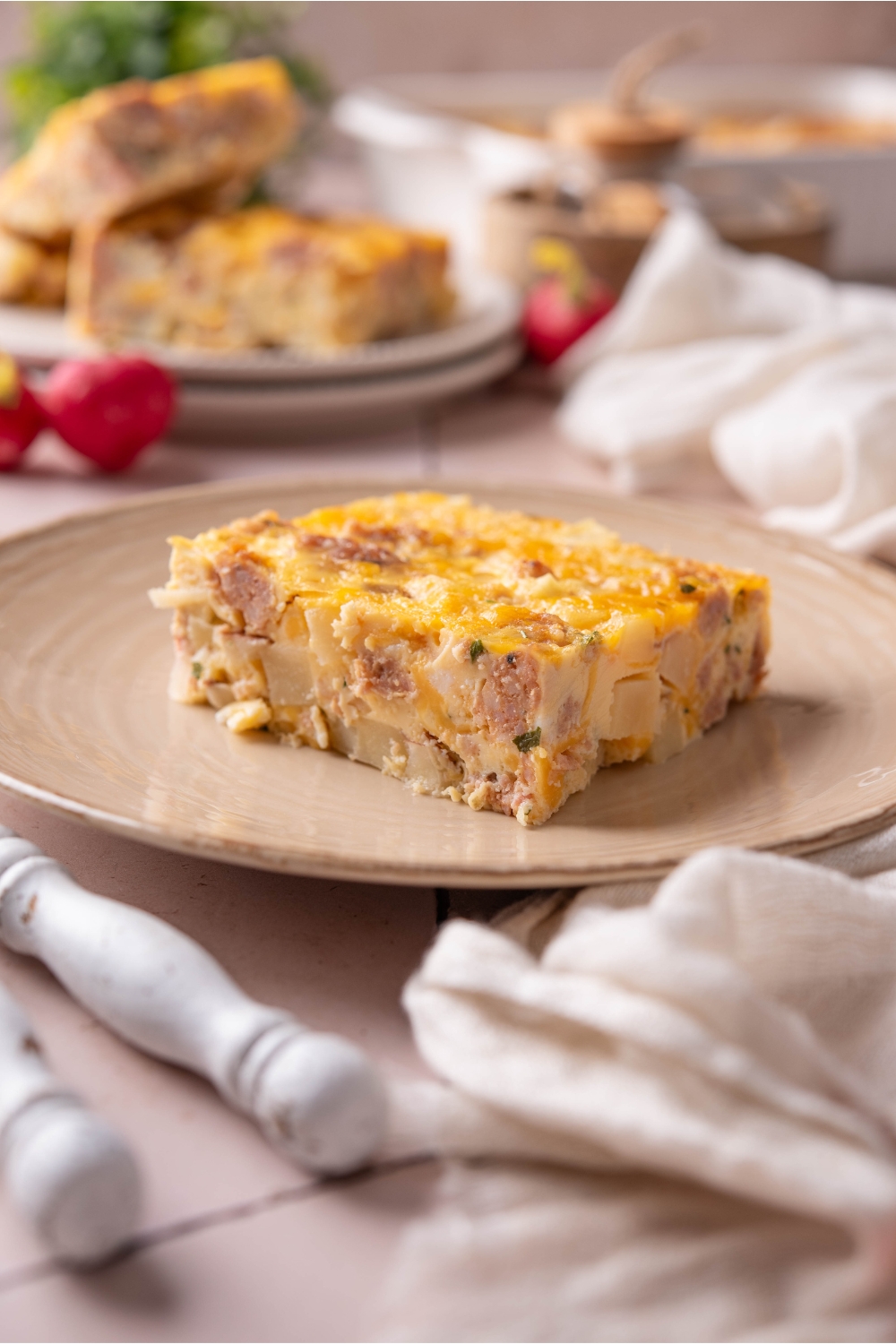 A plate with a square of hash brown casserole.