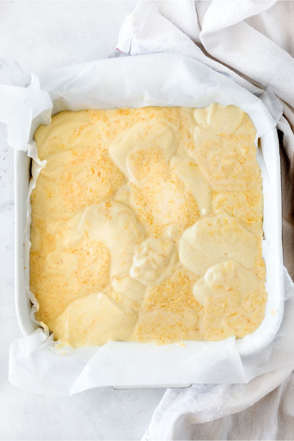 A pan with unbaked pumpkin cheesecake.