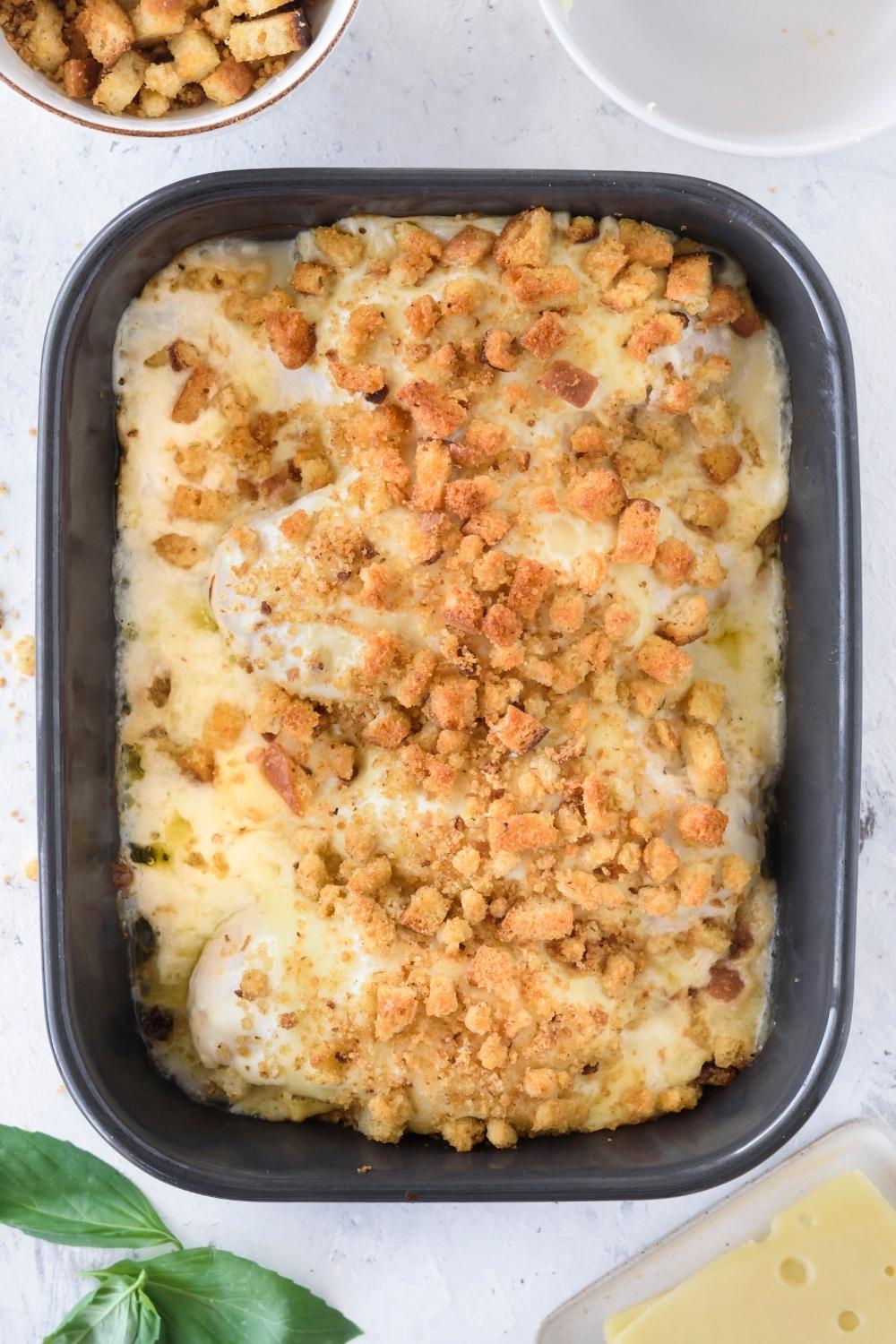 A casserole dish with baked swiss chicken casserole.