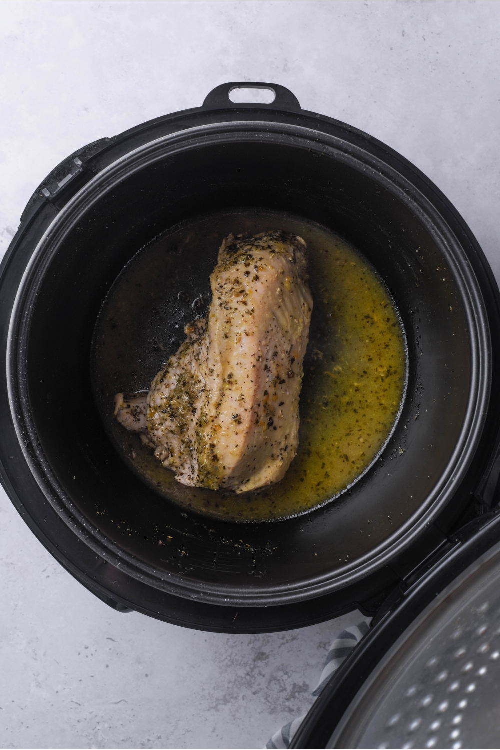 Cooked turkey tenderloin in a crock pot.