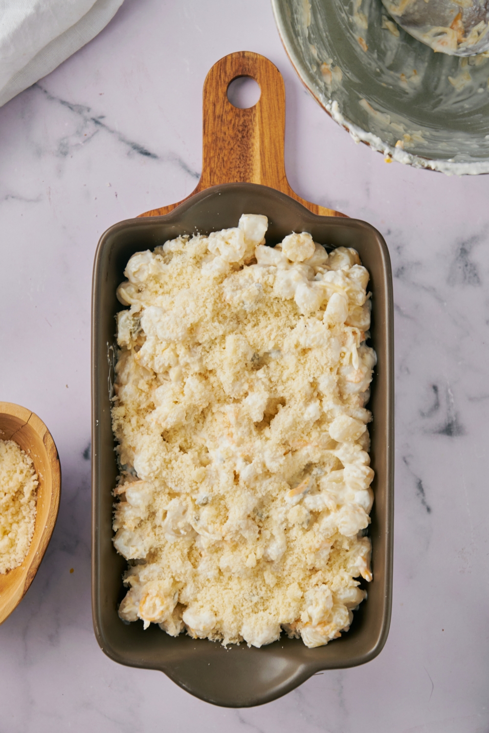 Uncooked hominy casserole in a black casserole dish