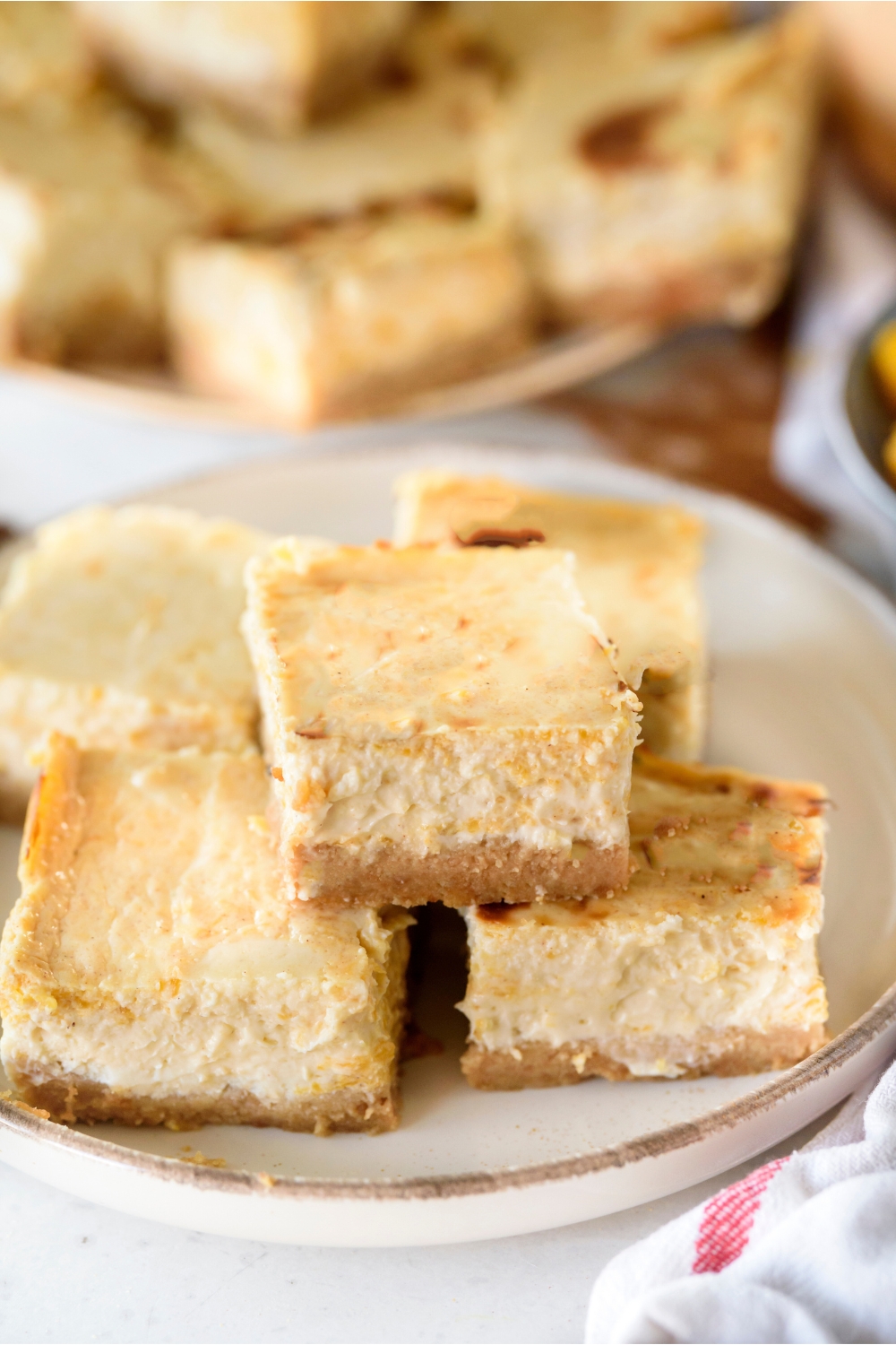 A plate full of pumpkin cheesecake bars.