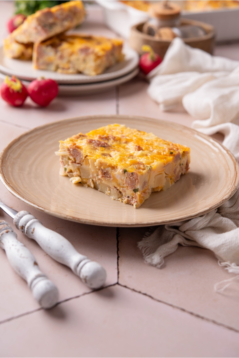 A plate with a square of hash brown casserole.