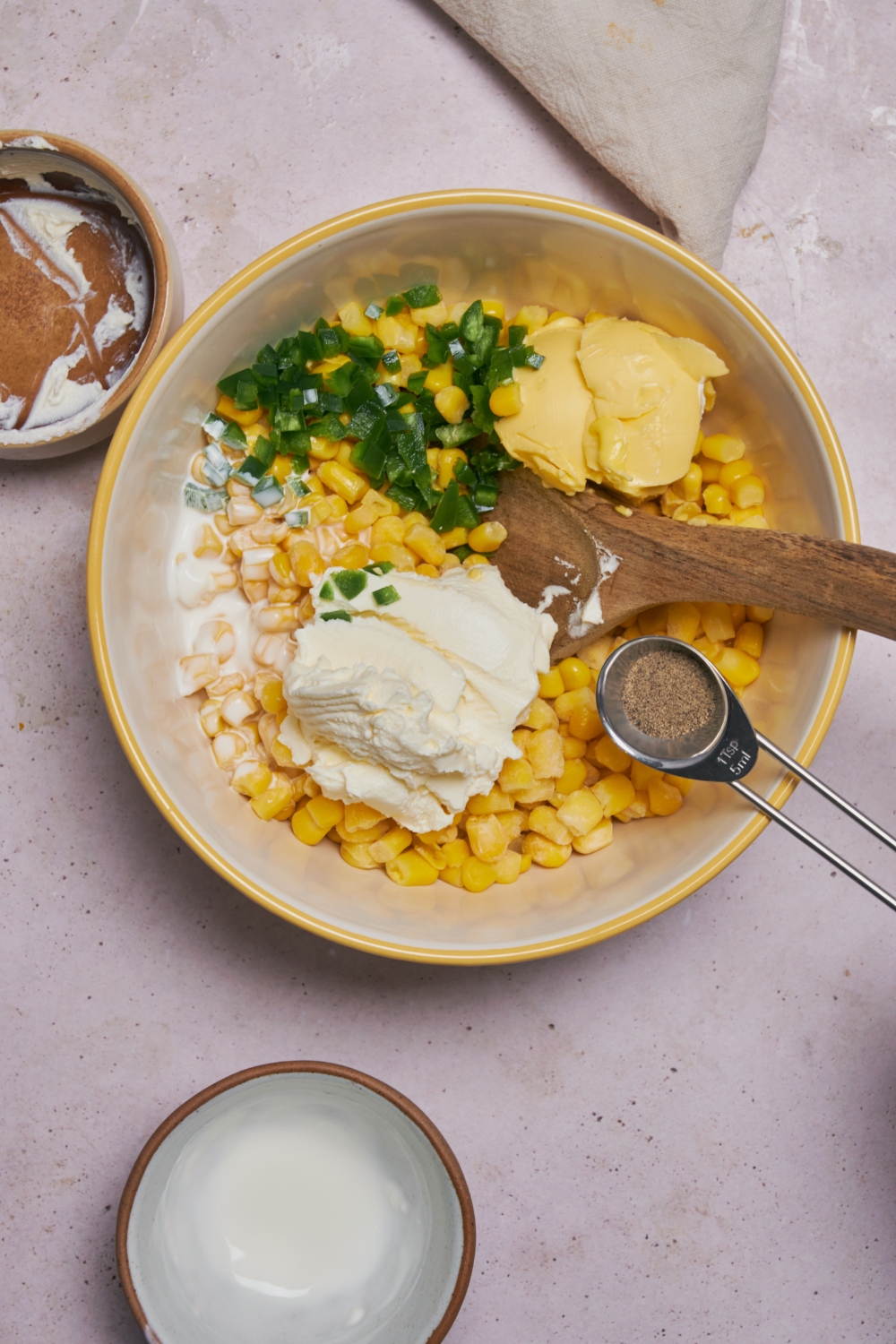 Ingredients for jalapeno corn casserole in a white mixing bowl