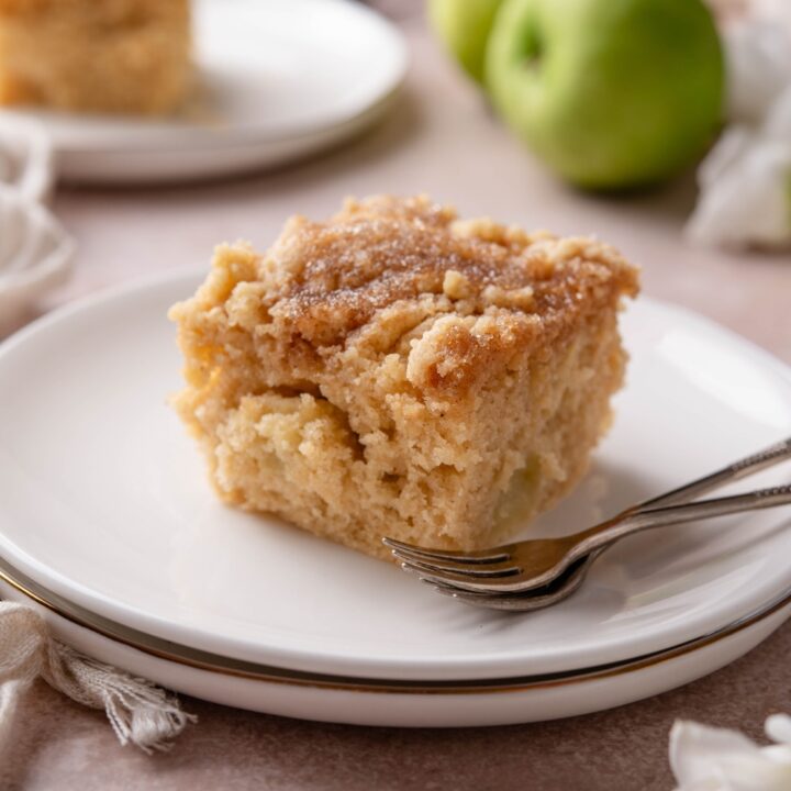 A plate with Apple Coffee Cake and two forks next to it.