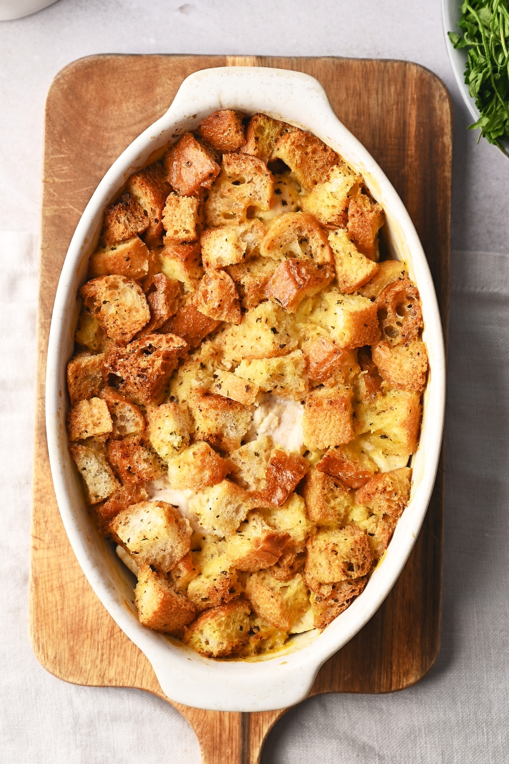 A baking dish filled with casserole topped with crispy stuffing.