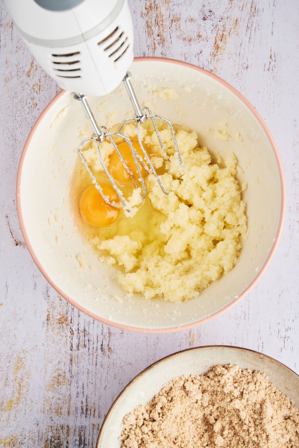 A mixing bowl with eggs added to the creamed butter mixture.