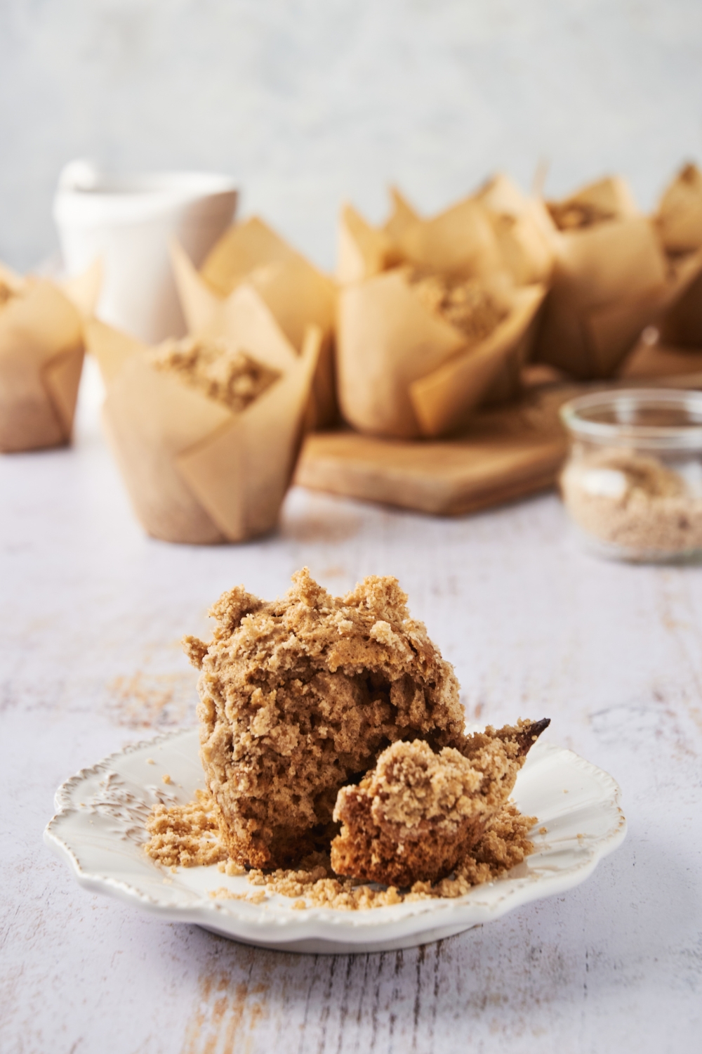 A plate with a cinnamon streusel muffin.