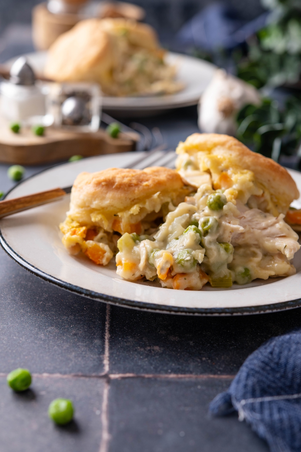 A completed dish of chicken pot pie on a white plate with a fork.