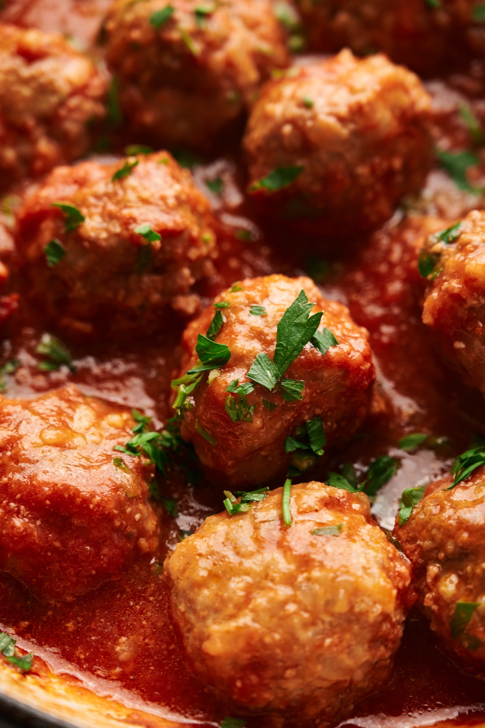 baked porcupine meatballs in a red sauce garnished with parsley