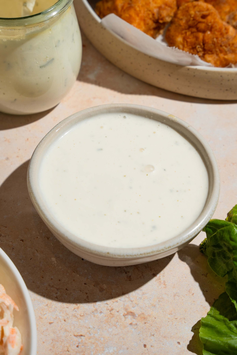 A white bowl that is filled to the brim with wingstop ranch dressing.
