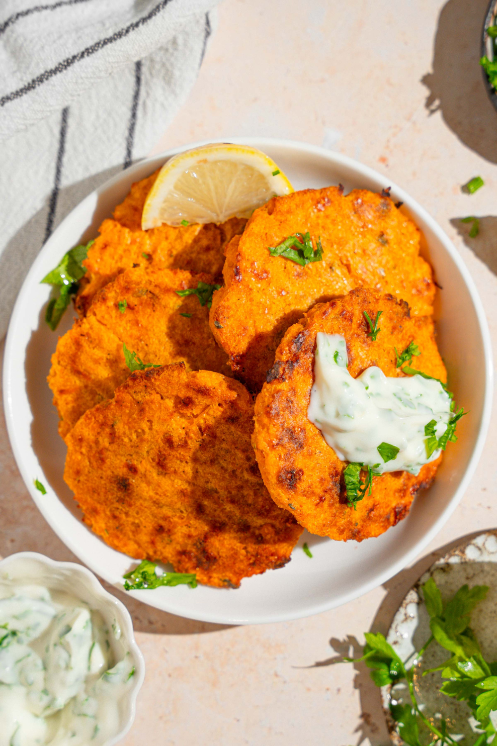 Six sweet potato patties, arranged in a circle eye white plate.