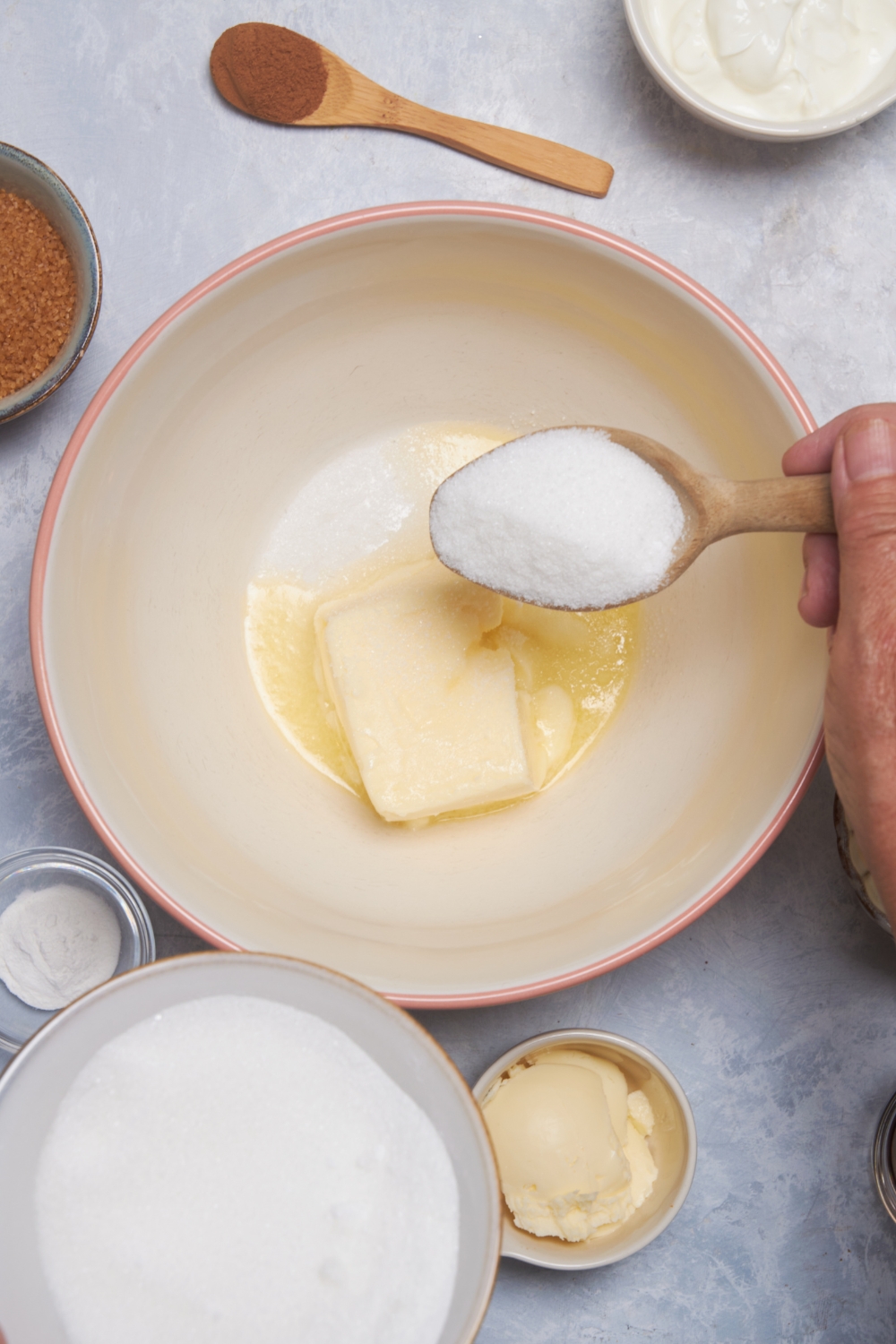 butter and a spoonful of sugar in a white mixing bowl