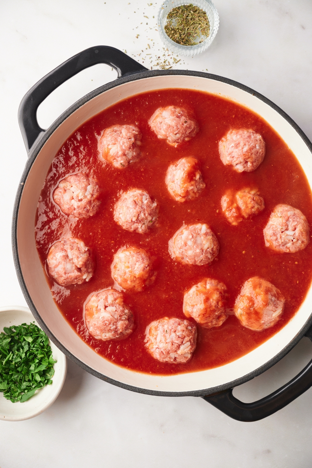 raw meatballs in tomato sauce in a pot