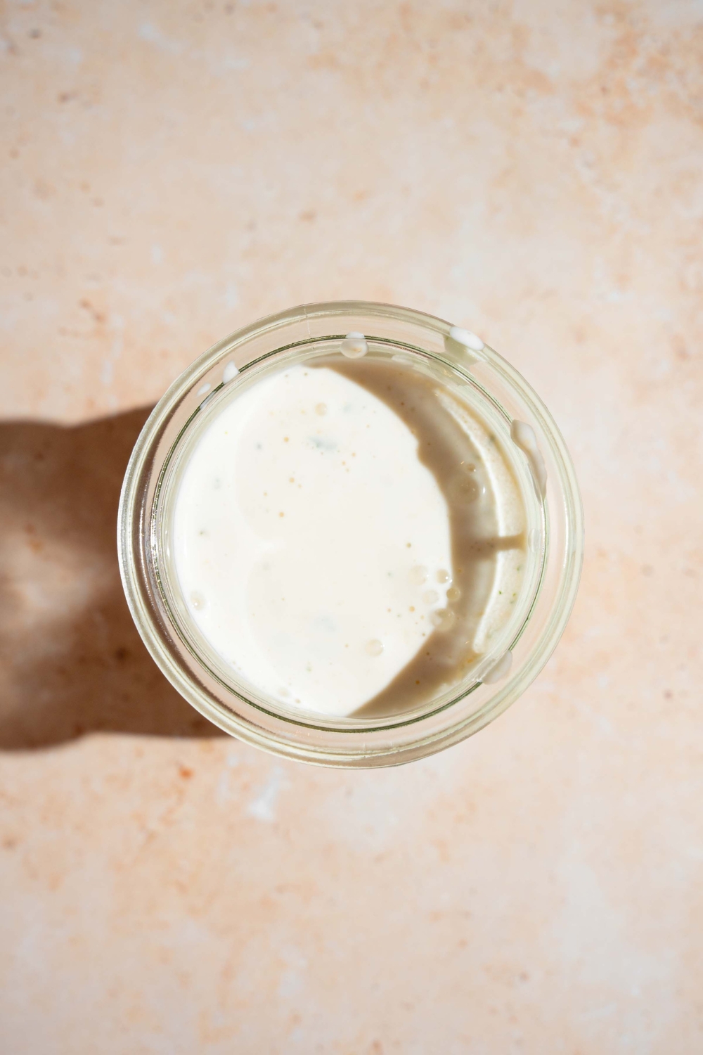 Ranch dressing in a blender on a white counter.