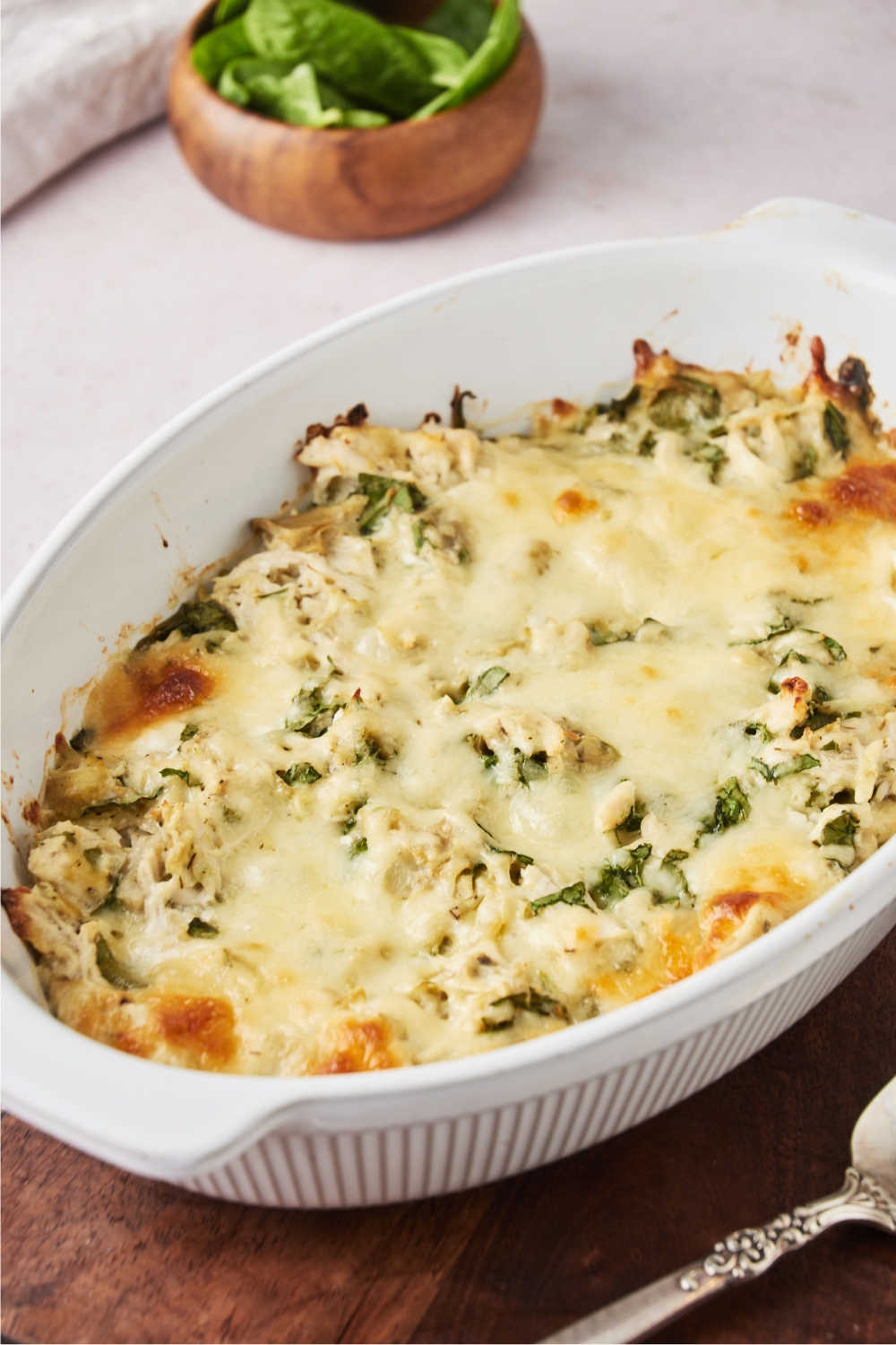 A baking dish filled with casserole covered in melted cheese.