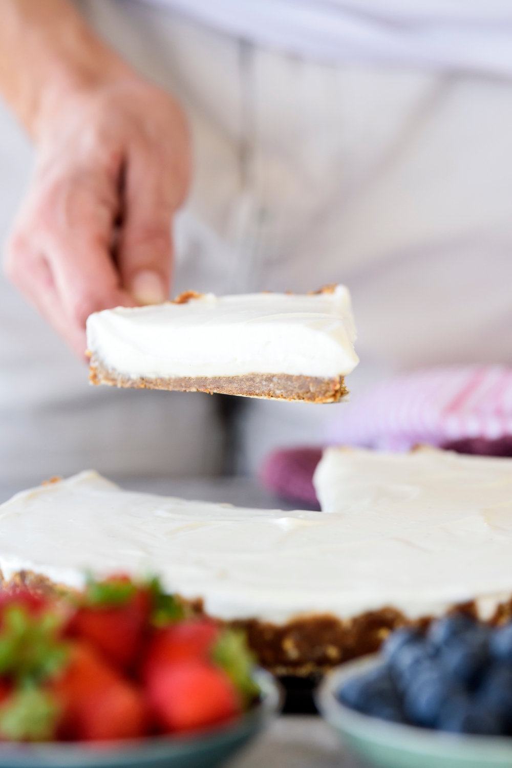 A slice of Cool Whip pie being held above the rest of the pie using a cake slicer.