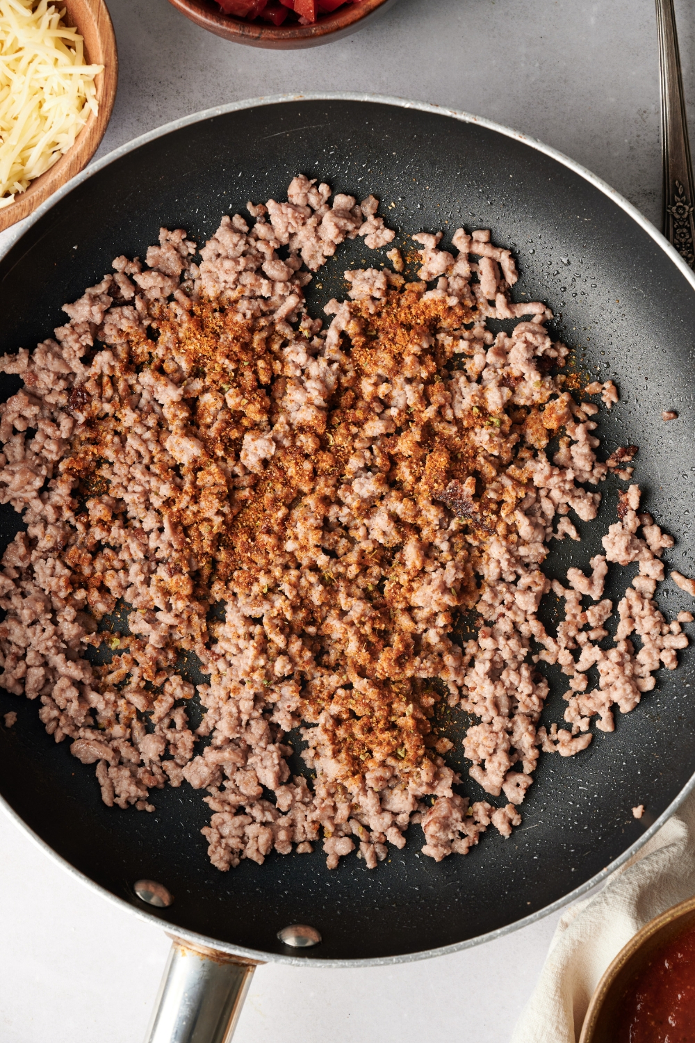 A skillet filled with cooked seasoned ground beef.