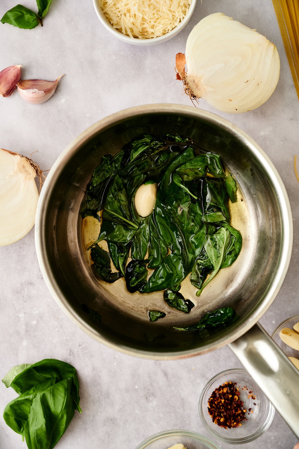 basil, garlic, and oil simmer in a sauce pan.