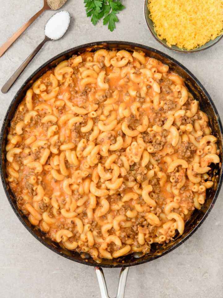 A skillet filled with hamburger mac and cheese.