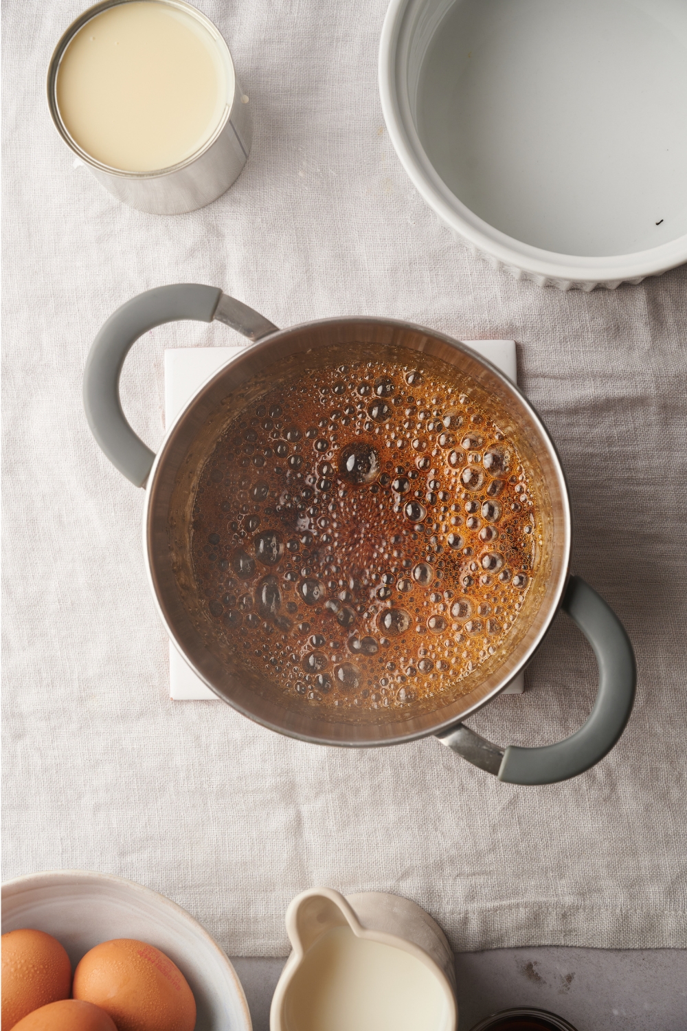 A pot with browned sugar cooked with water.