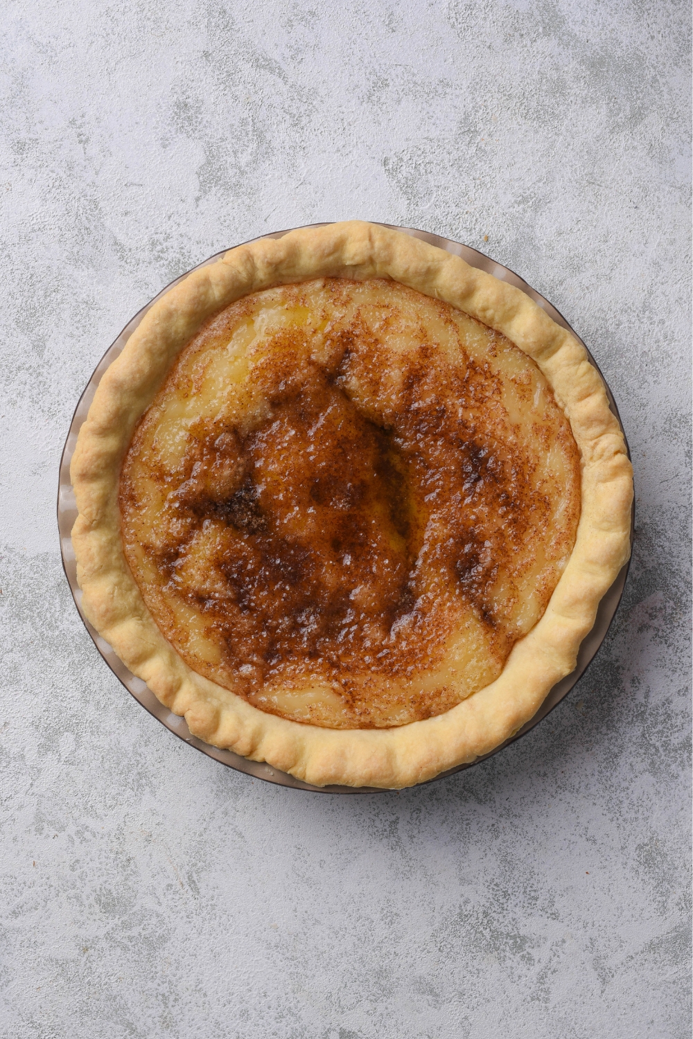 A baked sugar cream pie without cinnamon sugar topping.