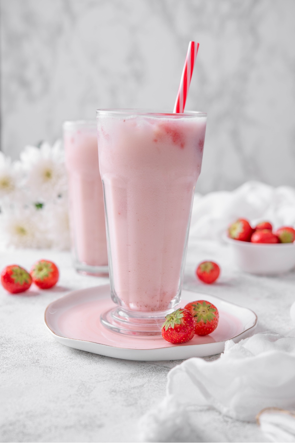 A tall glass with a straw and copycat Starbucks pink drink.