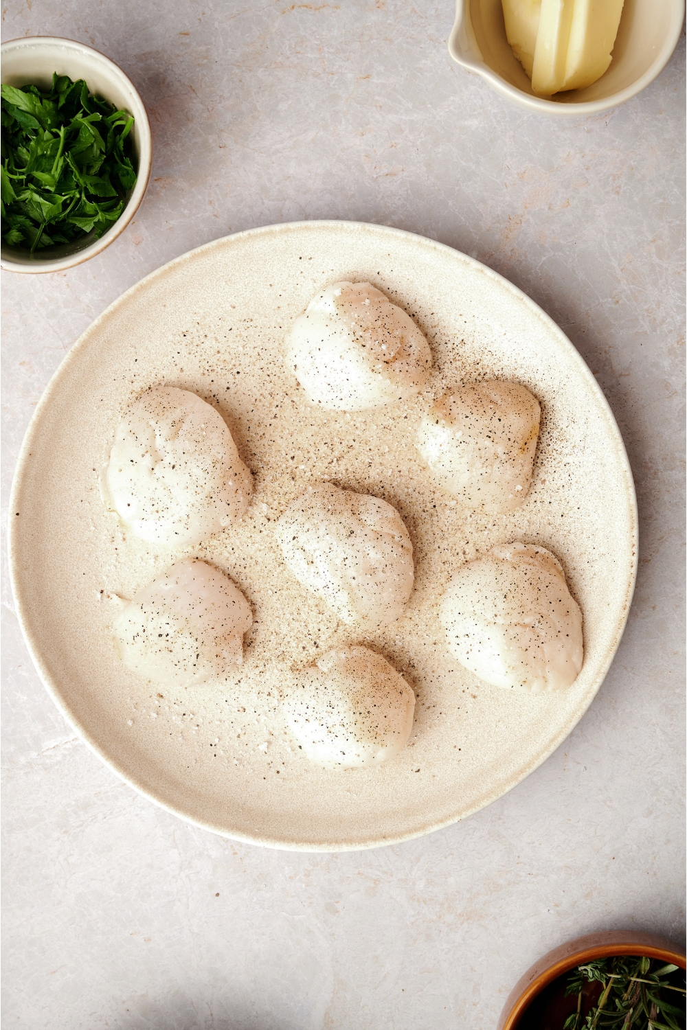 A plate with seasoned scallops.