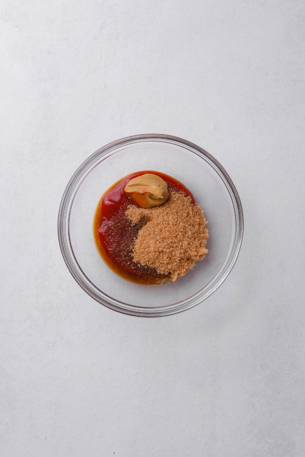 A small bowl with ketchup, mustard, Worcestershire sauce, and brown sugar.