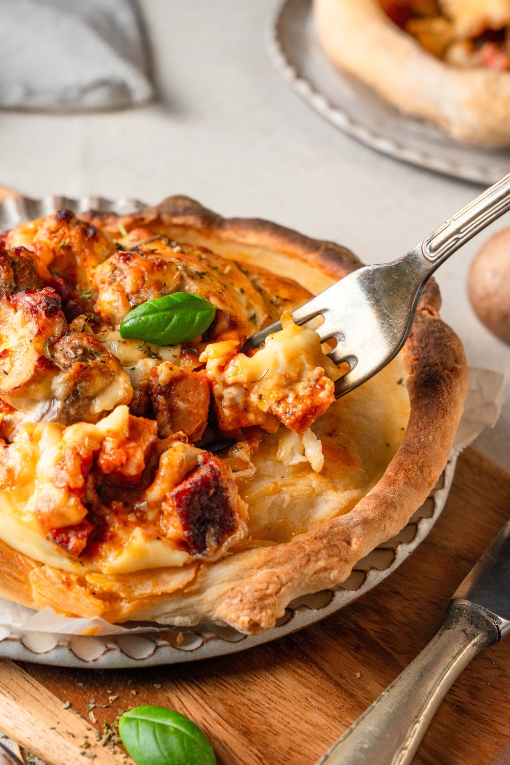 Someone picks up a bite of Chicago pizza pot pie with a fork.