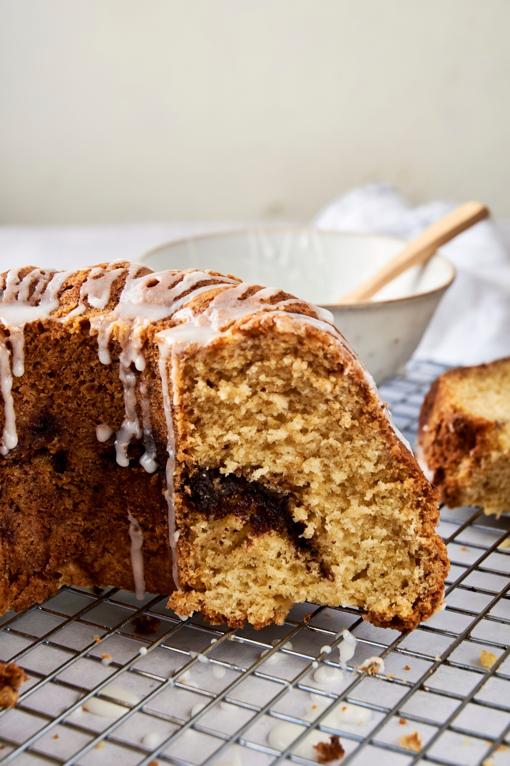 The remaining bundt cake on the wire rack.